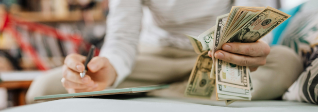 woman counting and documenting money