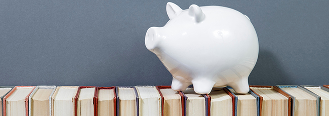 piggy bank on top of books