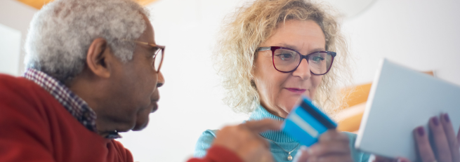 Man and woman looking at a debit card
