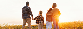 family overlooking the sunset