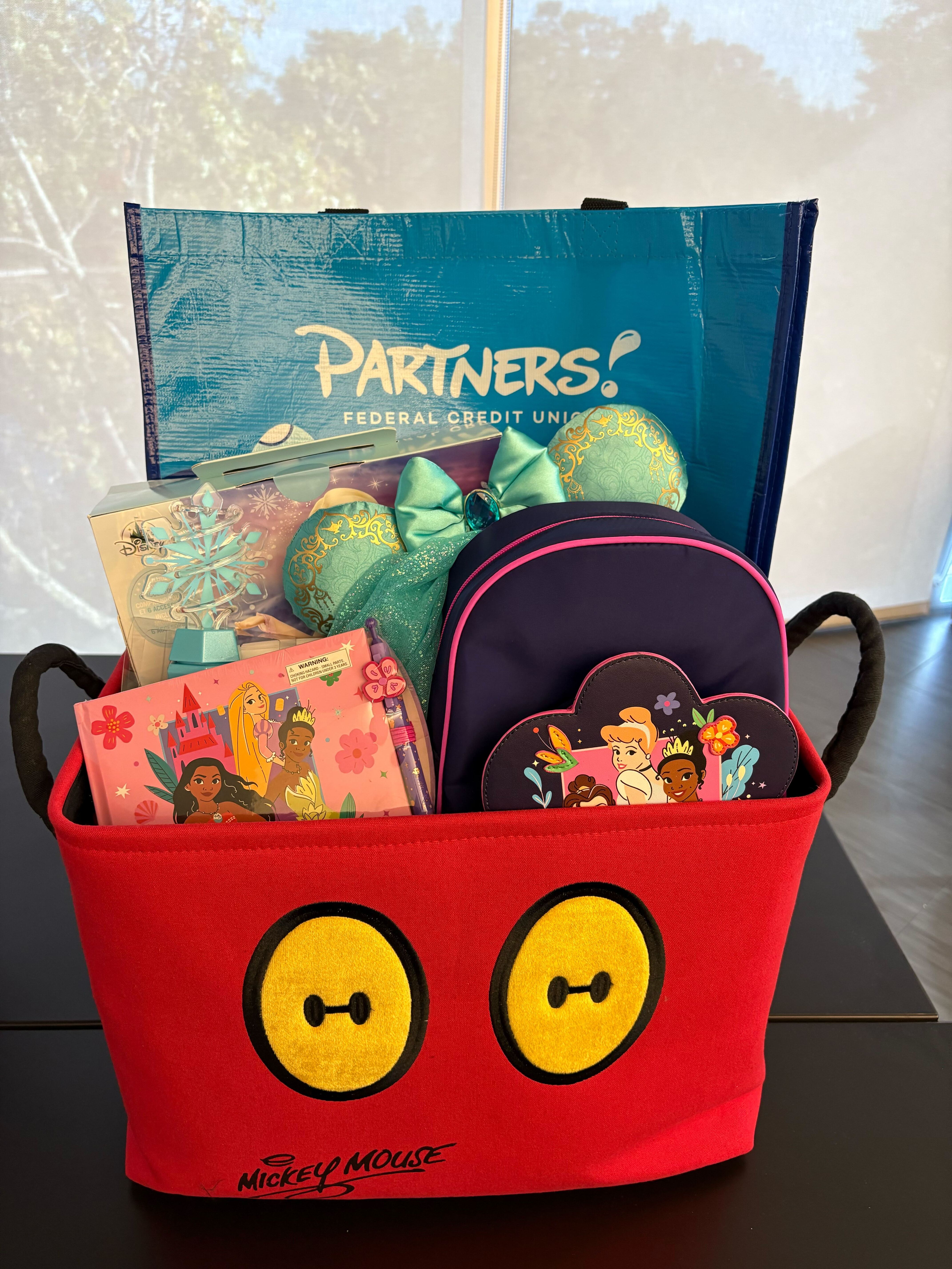 Mickey Mouse basket with a bag, princess back pack, book and ears inside
