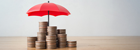 stack of coins underneath an umbrella
